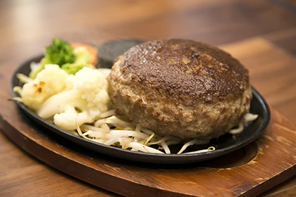 牛赤身肉のハンバーグ450g(2916円・税込)。つけ合せは脂肪燃焼を促すビルダー御用達のブロッコリー。塩コショウ味に飽きたら、テーブルに用意されているにんにく味噌、にんにくしょう油、おろしポン酢で味変可能