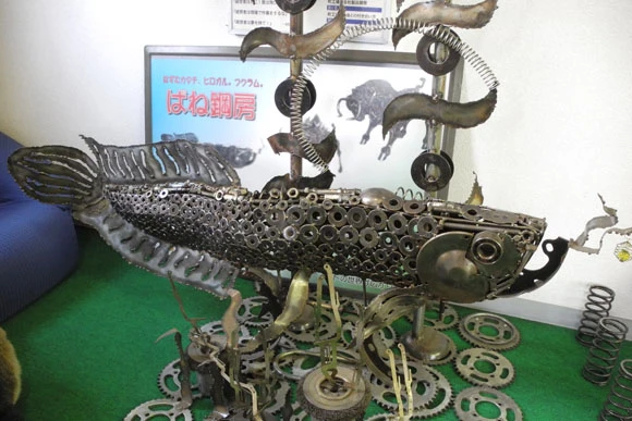 巨大魚(写真)や天井に届きそうなキリンなど工場内の至る所に社員が作ったバネ作品を展示。これも話題でメディアに取り上げられる
