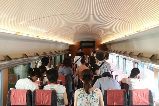 普通に乗車するならゆったりした座席で通路幅も余裕があるロマンスカーの車内。しかし、この日は50以上の媒体が集まったため、ごった返してしまい、撮影は2車両に分けることに