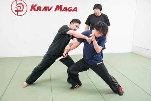 川畑インストラクター(左)と中村トレーナー(右)のデモ。中村氏が凶器で襲うところを、まず攻撃を止め、体を横にずらすのと同時に攻撃する。一瞬の出来事で終わる