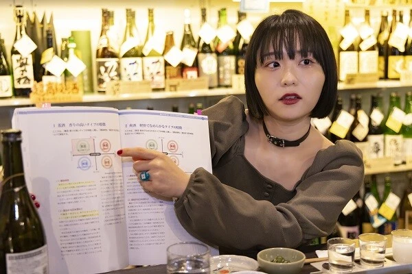 唎酒師の分厚い教科書を見せてくれる角井。「分厚いけど、意外と覚えちゃったよ」