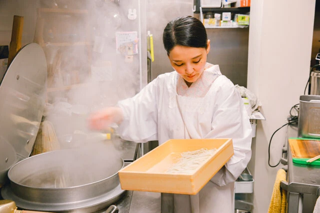 真剣な眼差しで、手早くかつ絶妙な力加減で愛情込めてそばを打つ絵里奈さん。時間帯によっては店外の窓からライブキッチン風に職人の技を覗ける