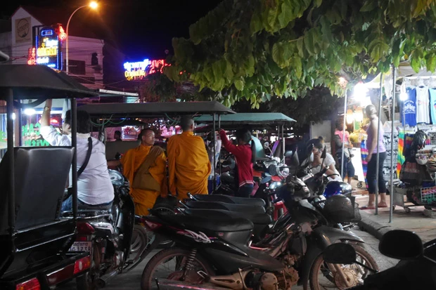 トゥクトゥクとたむろするオレンジの袈裟のお坊さん