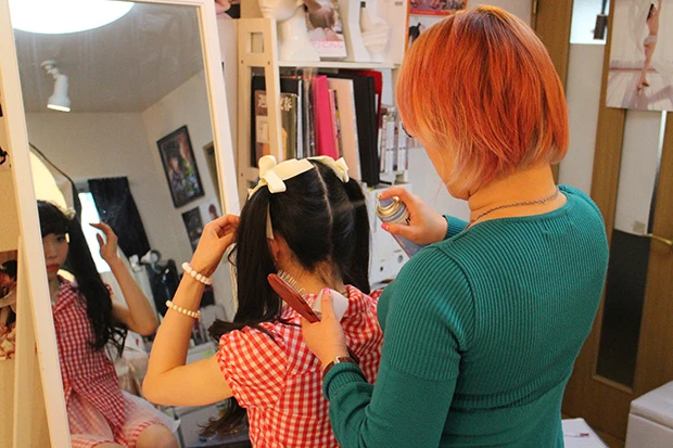 撮影をしながら、何か足りないと思ったら即座に対応。カメラを置いて今度はヘアメイクに。