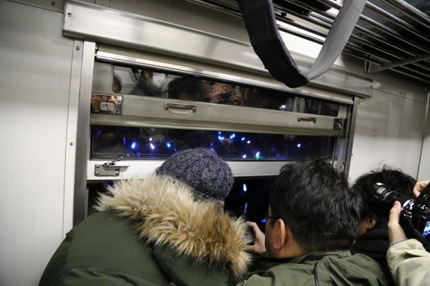窓の外では町民の持つサイリウムが青く光る