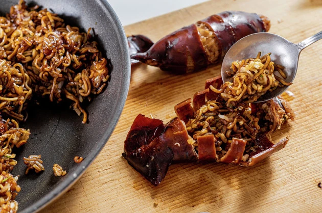 （４）詰める！　（２）で仕上げたそばめしをいかめしの抜け殻にたっぷりと詰め込み、ひっくり返して切れ目を隠したら完成。仕上げにおにぎりを握るように全体を握ると型崩れしにくくなる