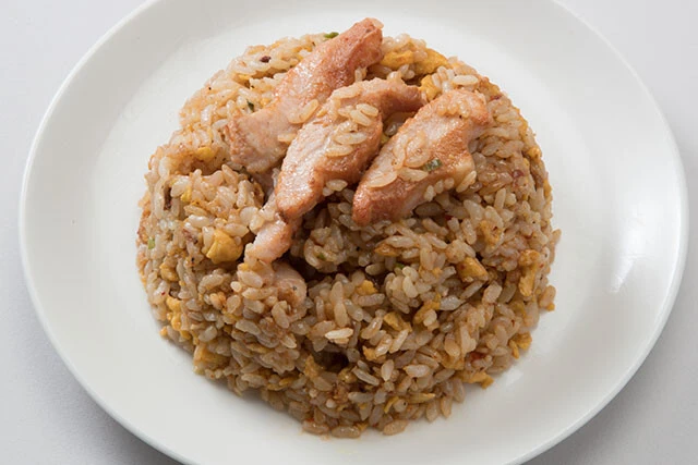 赤い豚とろチャーハン【冷凍チャーハン＋豚とろ焼き】①豚とろ、冷凍チャーハンを袋の表示どおり加熱したら、熱いうちにとんこつ辛味噌とともに混ぜ合わせる