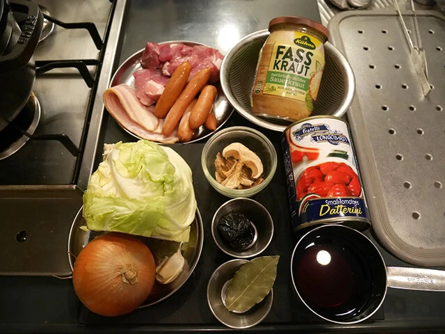 材料：ベーコン、ソーセージ、お好みの肉、ザワークラウト、キャベツ、たまねぎ、ニンニク、乾燥ポルチーニ、プルーン、ローリエ、トマト缶（他、塩胡椒）