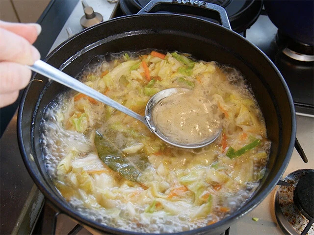 ４．肉を戻し、水、コンソメ、ローリエを入れ一煮立ちさせ、アクを取り除く