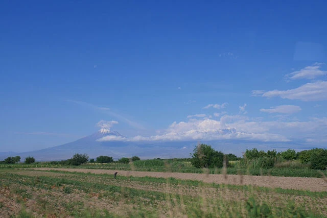 バスに揺られ富士山のような山を遠くに望みながら