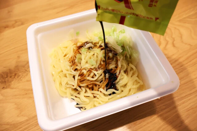 (3)仕上げ! (1)と(2)を容器に戻し、ソースを加えて全体をよくかき混ぜたら、ふりかけとペパたまをかければ完成。麺の量が多く味が薄くなってしまった場合はペパたまの量を増やすとよい