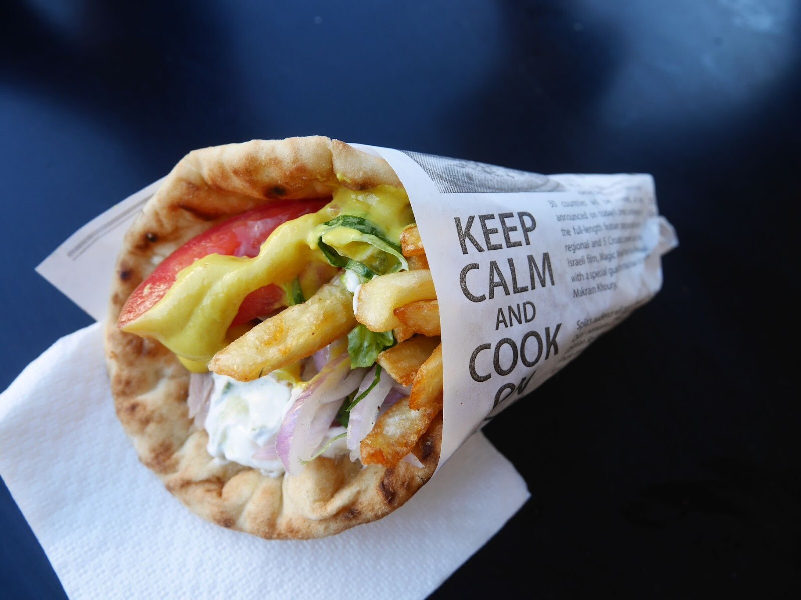 薄切り肉と野菜、どっさりポテトにヨーグルトベースのソースでギリシャ風