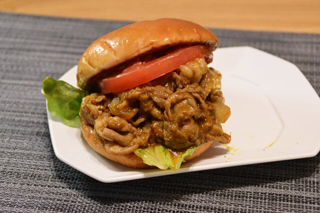 (3)挟む! (1)でパティを抜いた黒毛和牛バーガーに(2)で用意した牛肉をすべてのせ、再びバンズで挟めばカレギュウバーガーの完成。カレーが垂れやすいので包み紙に戻して食べること