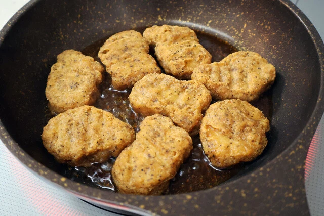 (3)煮詰める! めんつゆとぽん酢を1:1で混ぜたタレを作り、フライパンで加熱。煮立ったらナゲットを投入する。ひっくり返しながら煮詰めてタレを吸収させていくといい感じにとろみも出る