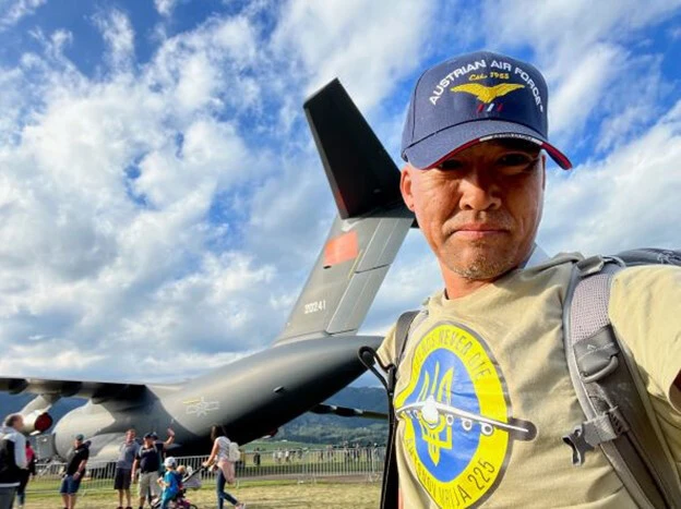 スロバキアで買ったウクライナ応援Tシャツを着用して、オーストリアに飛来した中国空軍Y20輸送機の前で意味深い撮影をする柿谷氏