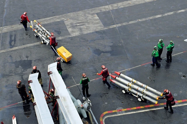 ボム・ファームからヒートミサイルやレーダーミサイルを次々とドリー（運搬車）に載せ、飛行甲板の艦載機へと運ぶクルー