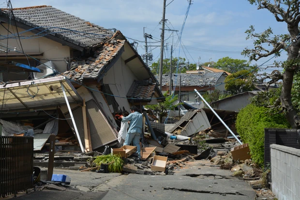 倒壊した自宅に着替えの衣類などをとりにきた被災者