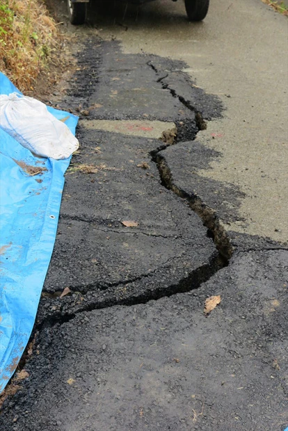 写真の場所は地割れした後、アスファルトできれいに舗装されたのだが、たった1日で、再び同じ箇所に亀裂が入っていた
