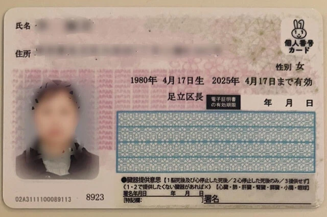 筆者が入手した偽造マイナンバーカードのサンプル。確かに角度を変えても「マイナちゃん」の背景色は変わらないが……