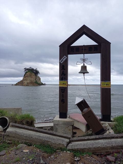 垂直に屹立する雄姿から「軍艦島」と呼ばれた観光名所・見附島(写真奥)はすっかり形を変えてしまった。能登町恋路海岸から続く「えんむすびーち」もダメージを受け、恋人たちは「縁結びの鐘」を叩けない