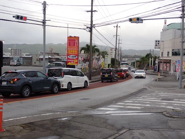 白銀橋（東）交差点。開業初日の午後、国道58号に出る信号を先頭に、県道84号は長い渋滞に見舞われた。那覇方面に戻る場合は、羽地内海側に進み、この交差点を迂回するほうが早くなるケースもある