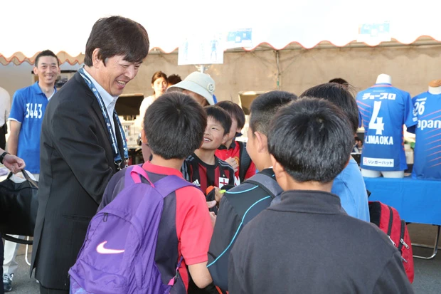 試合を見に来た子供たちに囲まれる髙田氏。長崎のサポーターからは絶大な支持を受けている